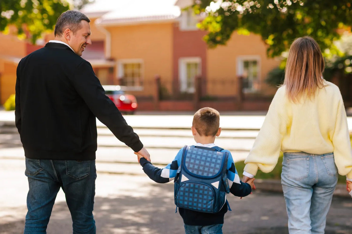 Parents walking their son to school