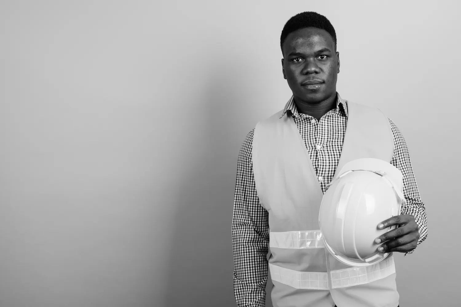 Construction worker holding a hard hat